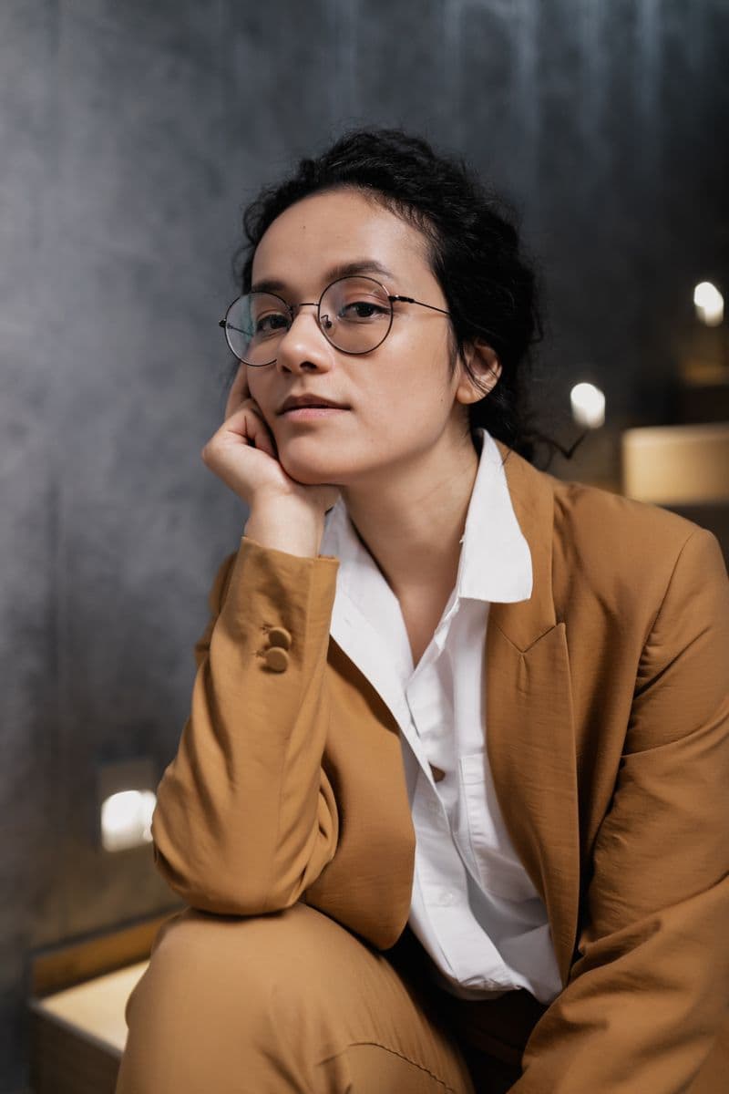 Portrait of Dr. Elena Marsh wearing round wire-frame glasses